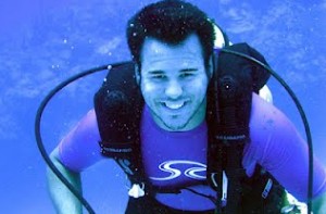 Jeff scuba diving smiling while holding regulator
