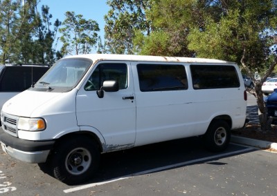 white van parked in an asphalt parking lot