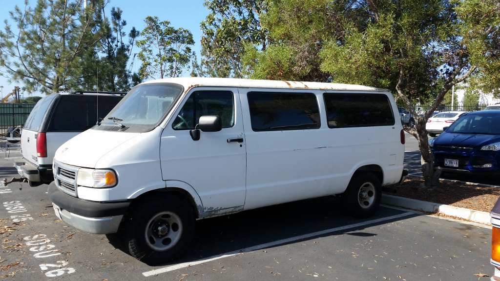 white van parked in an asphalt parking lot